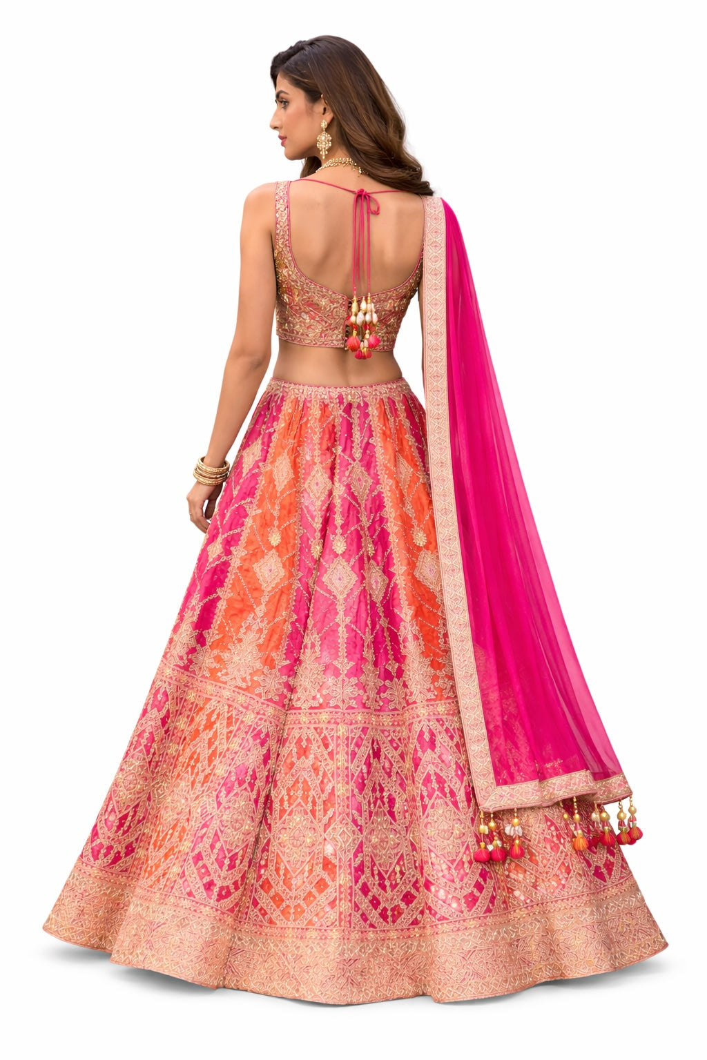 Woman wearing a colorful traditional outfit with a pink dupatta on a white background