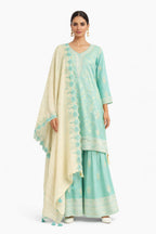 Model wearing mint and ivory embroidered sharara set – Khush Mizaj