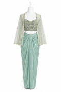 Mint green dhoti skirt with a matching blouse on a mannequin against a white background