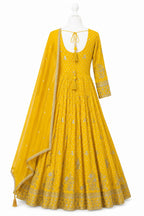 Yellow embroidered dress with dupatta on a mannequin against a white background