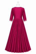 Fuchsia dress with white trim on a mannequin against a white background