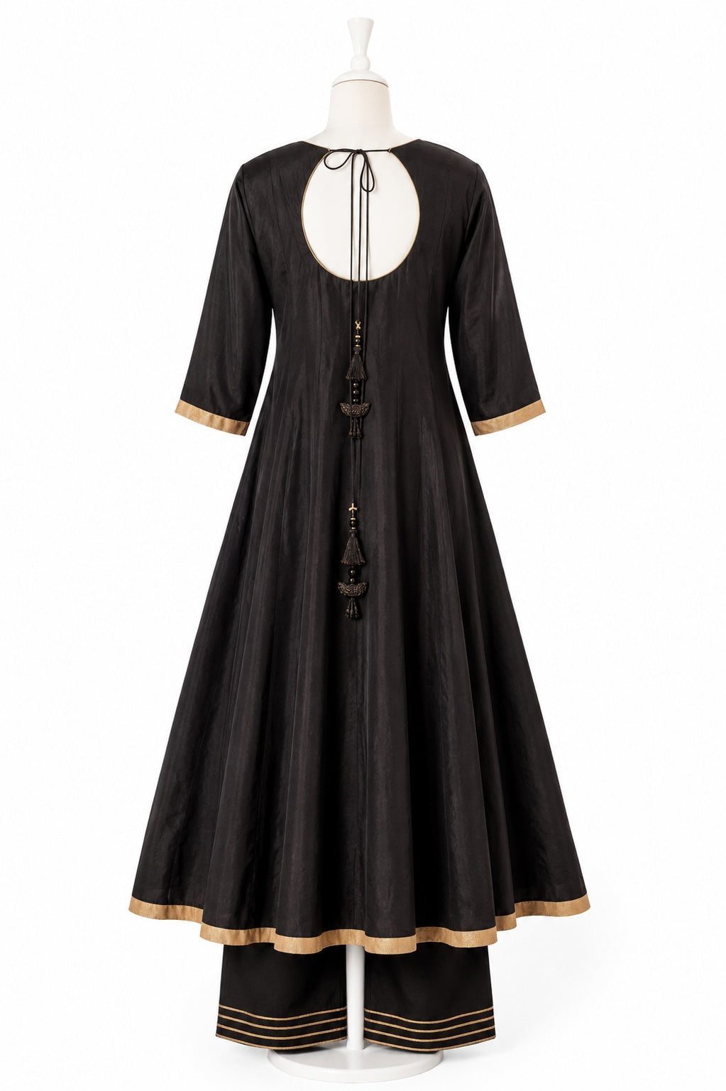 Black dress with gold trim on a white mannequin against a white background