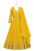 Yellow embroidered anarkali suit on a mannequin with a white background