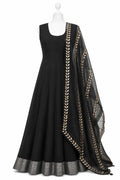 Black dress with gold embroidery on a mannequin against a white background