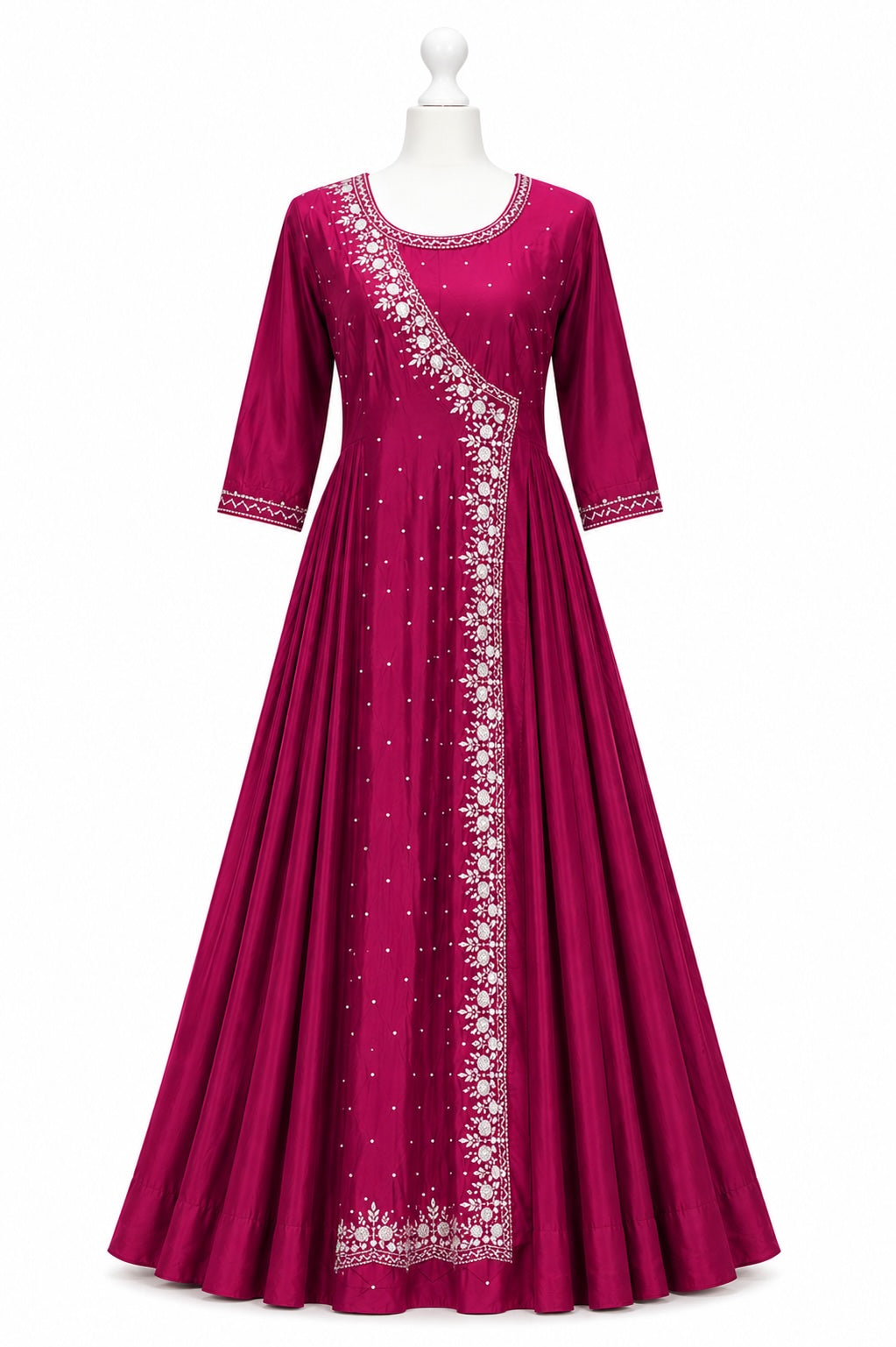 Magenta dress with white embroidery on a mannequin against a white background