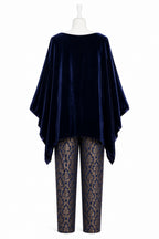 Navy velvet poncho over lace pants on a mannequin against a white background