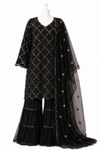 Black patterned outfit with a sheer dupatta on a white background