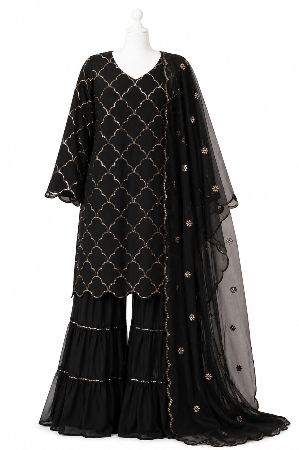 Black patterned outfit with a sheer dupatta on a white background