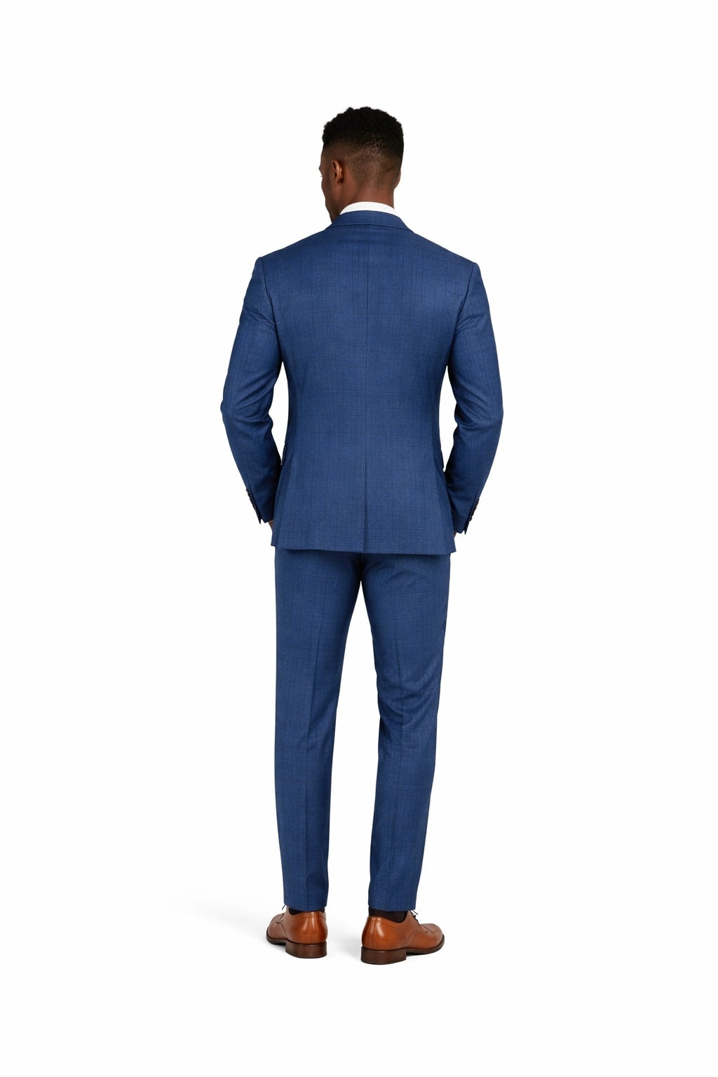 Man wearing a blue suit standing against a white background