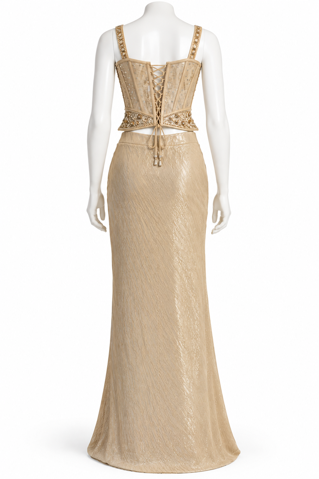 A floor-length champagne gold evening gown with a structured lace-up corset-style bodice and embellished straps, displayed on a white mannequin against a plain white background.