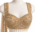 An ornate beige and gold embellished blouse top with intricate beadwork, sequins, and hanging tassel fringe, displayed on a cream mannequin torso against a white background.