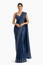 Woman wearing a blue saree with a white background