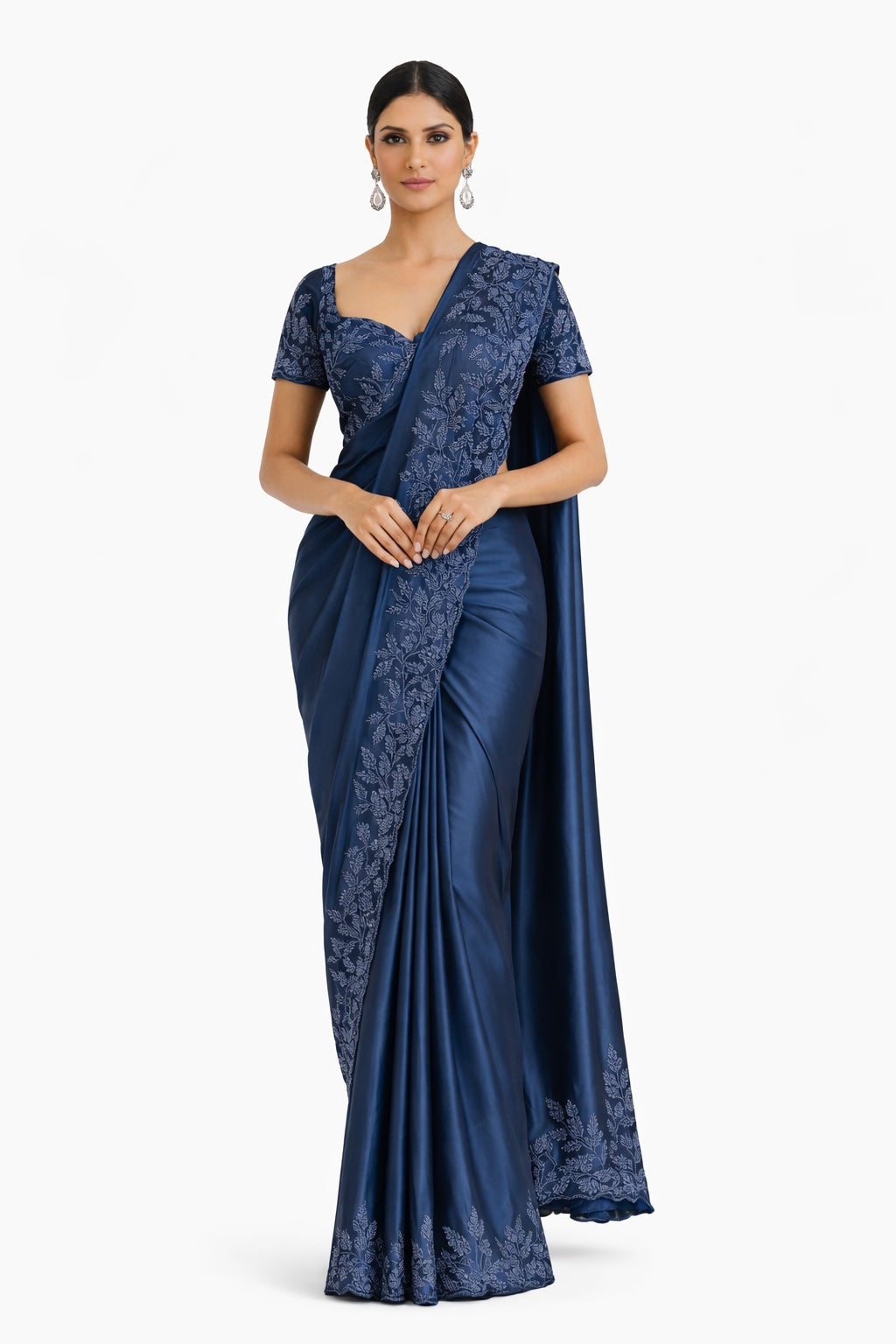 Woman wearing a blue saree with lace details on a white background