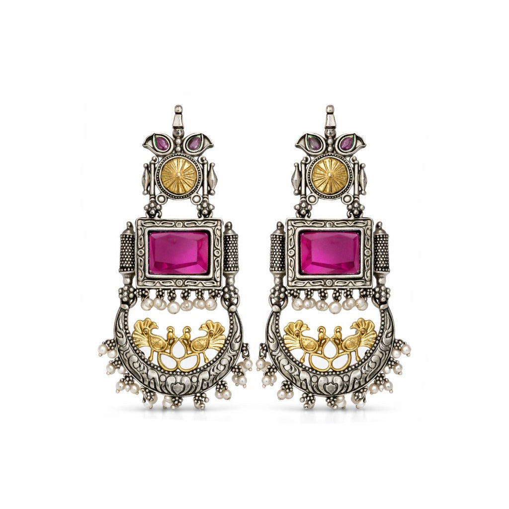 Ornate earrings with pink gemstones and gold accents on a white background