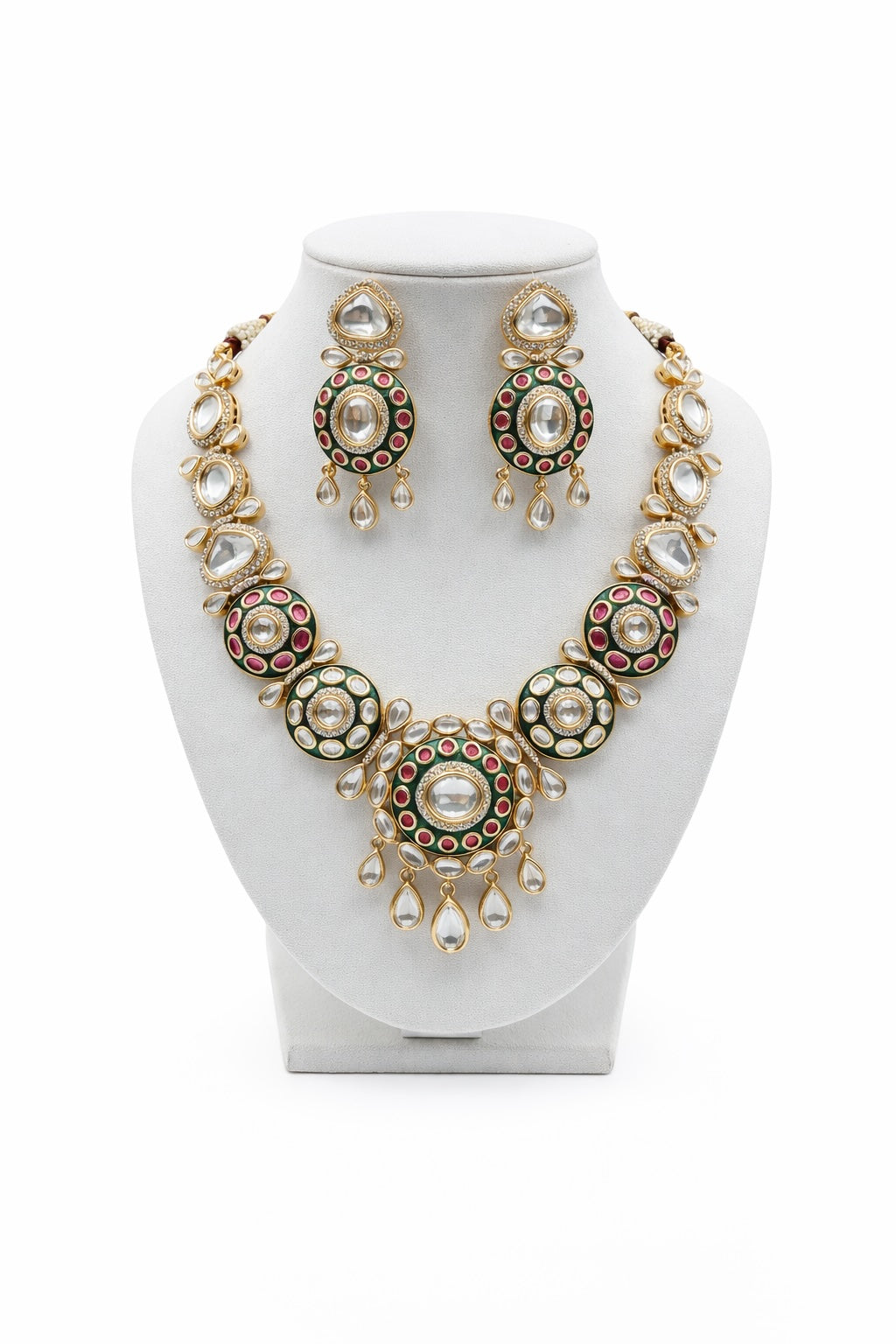Jewelry set with necklace and earrings on a white stand