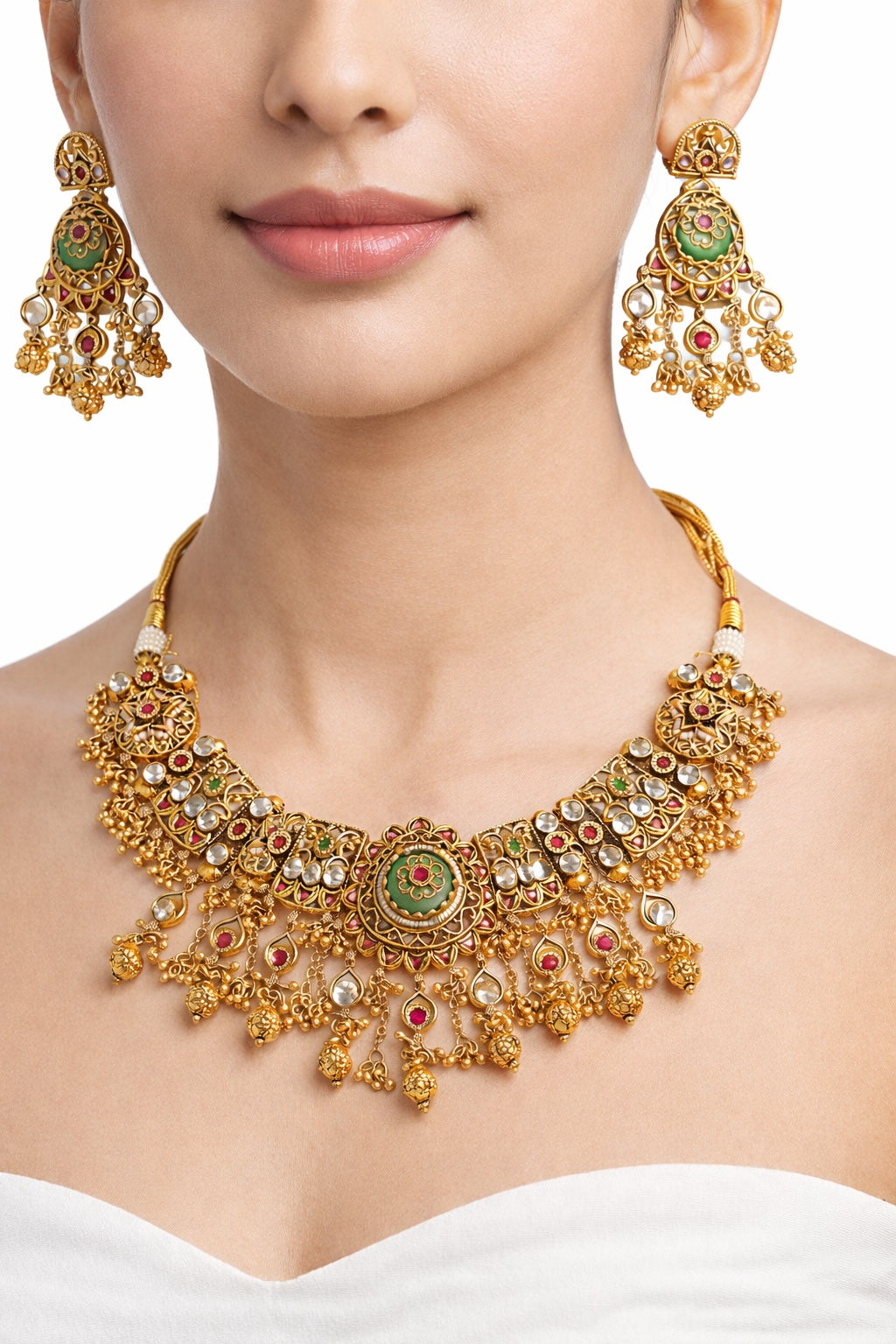 Gold necklace and earrings on a model with a white background