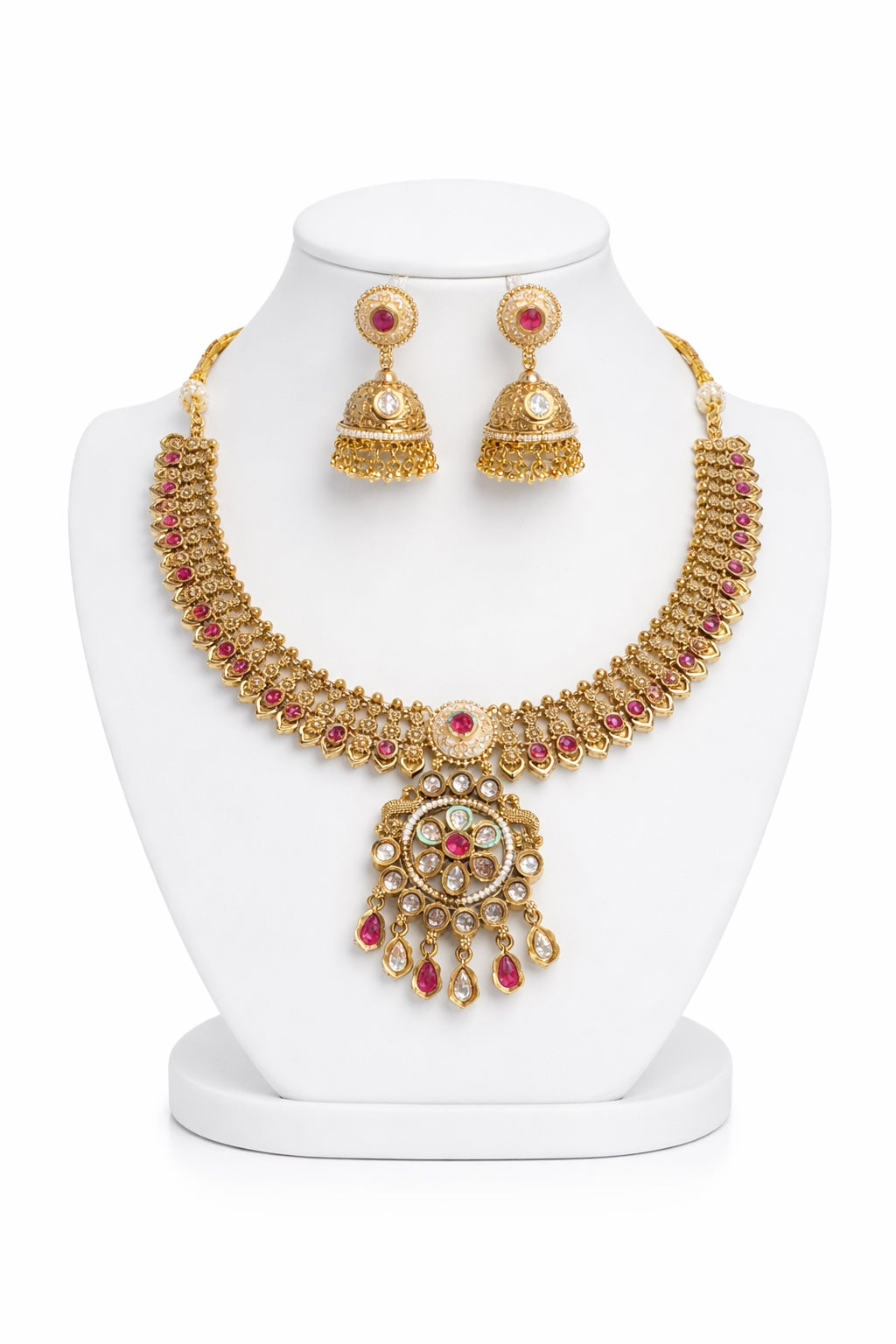 Gold necklace and earrings set on a white mannequin bust with a white background