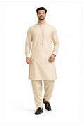 Man wearing a beige kurta with pants on a white background