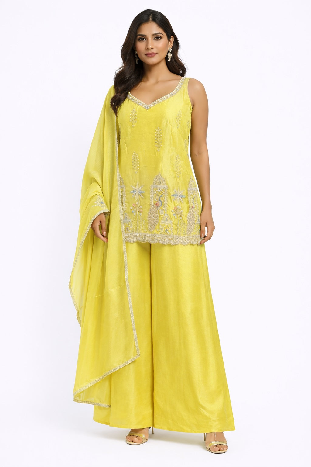 Woman wearing a yellow traditional outfit with a matching dupatta on a white background