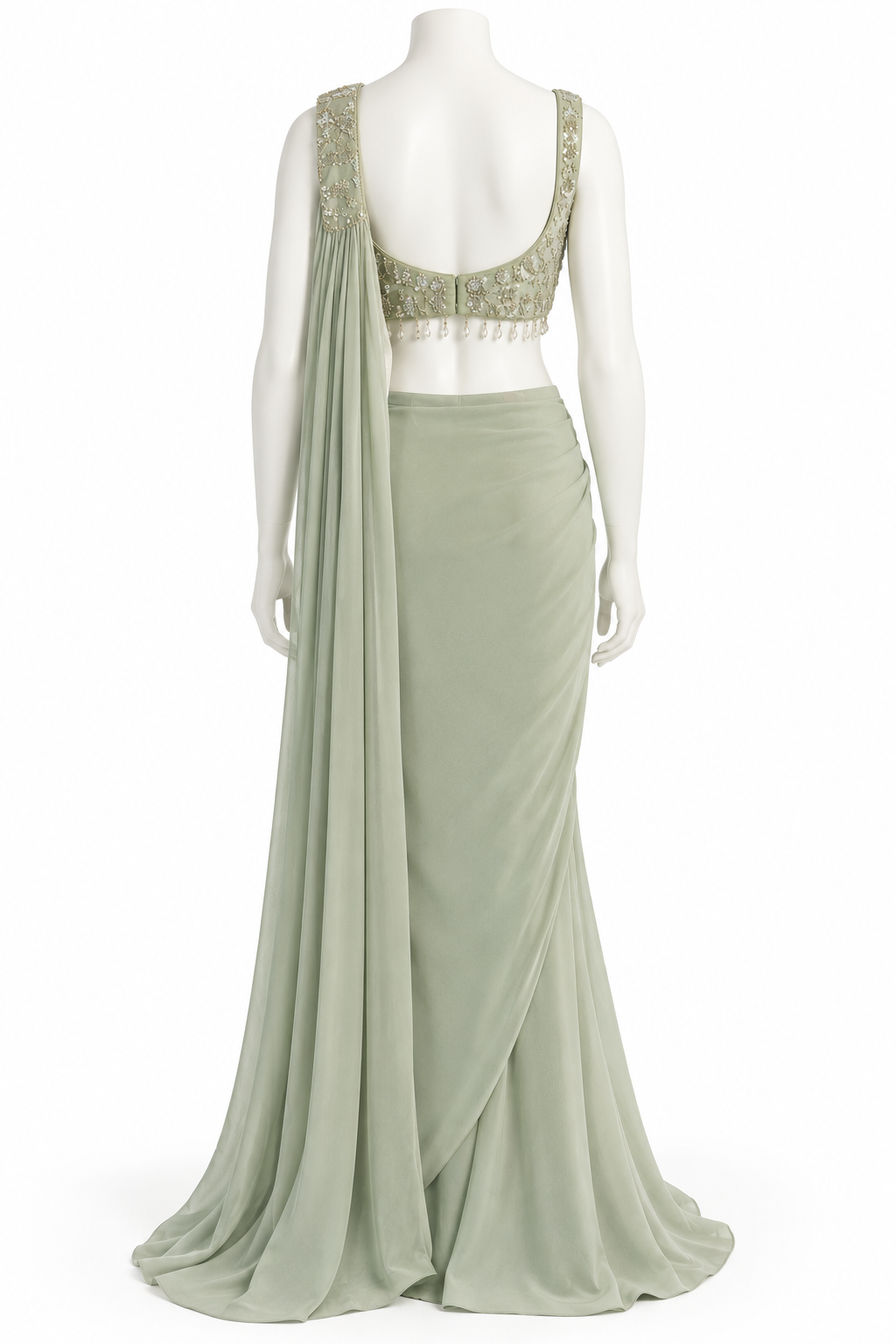 A sage green evening gown displayed on a white mannequin, featuring a sleeveless draped neckline with intricate gold embroidery and beadwork, a matching draped skirt, and a long flowing dupatta.