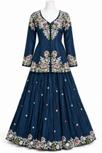 A navy blue traditional long gown with intricate floral embroidery in pink, white, and green, displayed on a white mannequin against a plain white background.