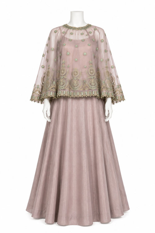 A dusty pink traditional Indian outfit displayed on a white mannequin, featuring a sheer embroidered kurta with wide bell sleeves and a matching pleated skirt.