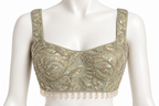 An ornate sage green and gold sequined crop top with beaded floral patterns and a pearl fringe hem, displayed on a white mannequin torso.