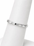 Silver ring with small diamonds on a white mannequin finger
