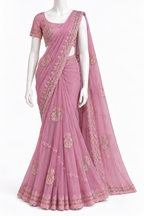 A pink georgette saree with gold floral embroidery, displayed on a white mannequin against a plain white background.
