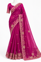 A magenta pink georgette saree with gold floral embroidery, displayed on a white mannequin against a white background.