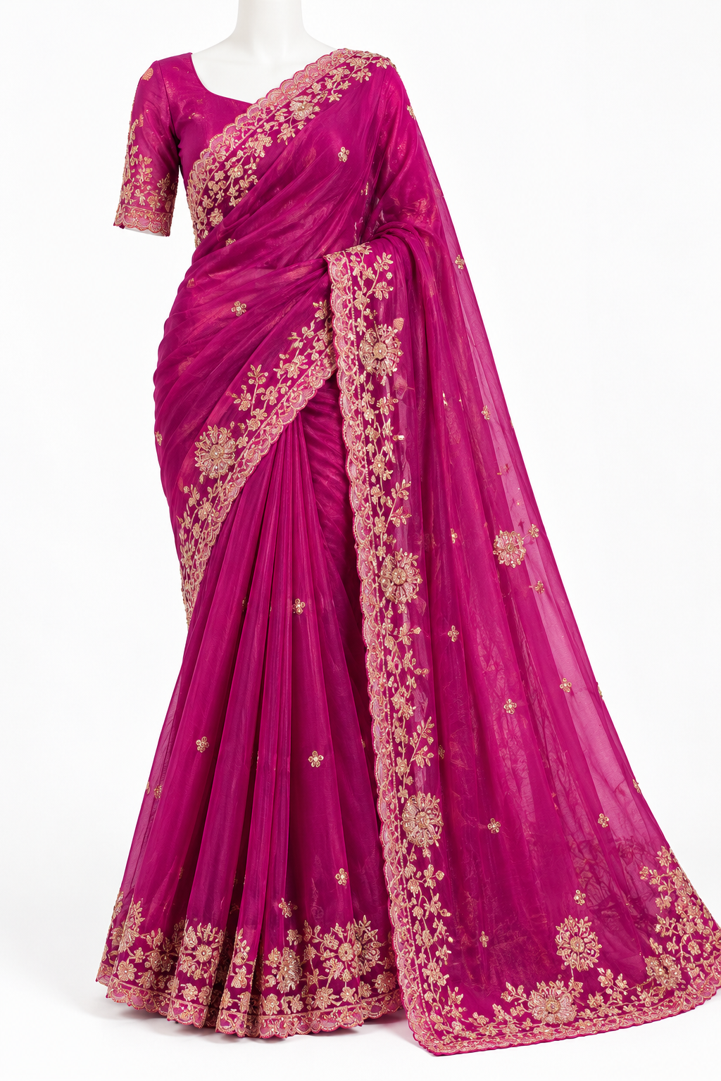 A magenta pink georgette saree with gold floral embroidery, displayed on a white mannequin against a white background.