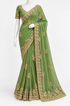 A sage green georgette saree with intricate gold floral embroidery, displayed on a white mannequin against a plain white background.