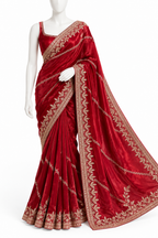 A deep red velvet saree with intricate gold floral embroidery, displayed on a white mannequin against a plain white background.