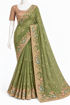 An olive green saree with intricate floral embroidery in gold, pink, and teal, paired with a matching beige embroidered blouse, displayed on a white mannequin against a plain white background.