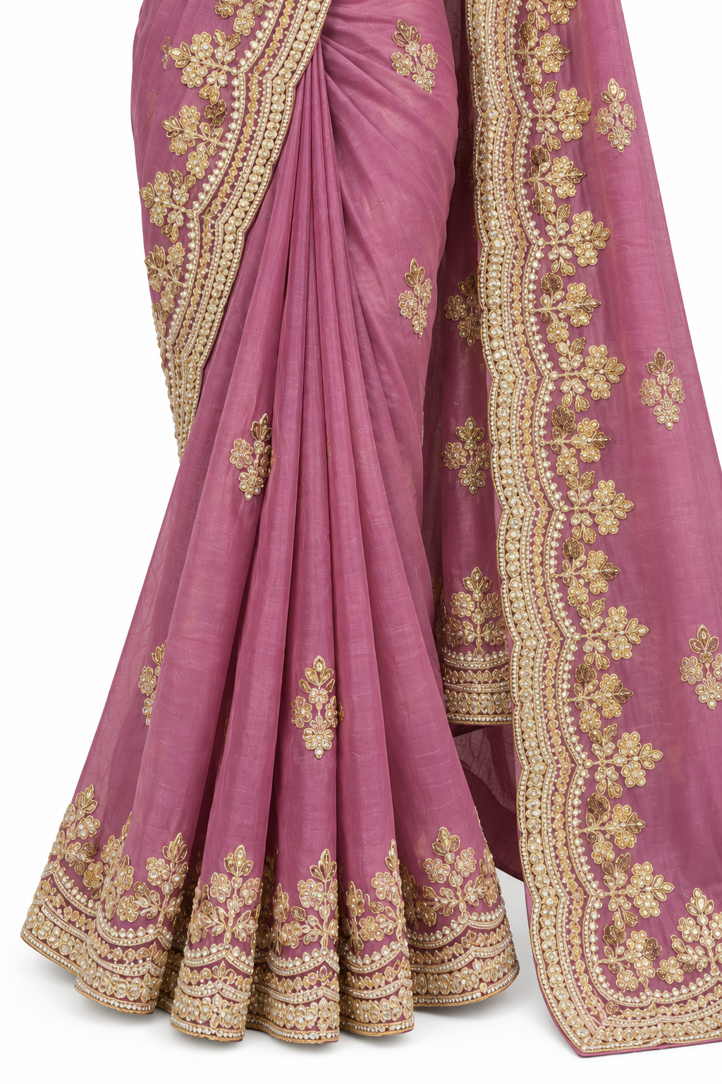 A draped pink saree with intricate gold floral embroidery and a wide decorative gold border, shown against a plain white background.