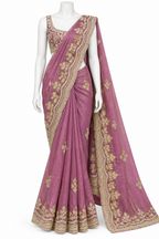 A mauve pink saree with intricate gold floral embroidery, displayed on a white mannequin with a matching embroidered blouse against a plain white background.