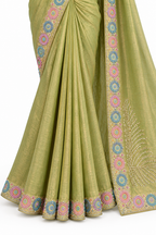 An olive green saree with intricate multicolor circular and geometric border embroidery, shown draped on a white background.
