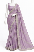 A lavender purple georgette saree with silver floral embroidery, draped on a white mannequin against a plain white background.