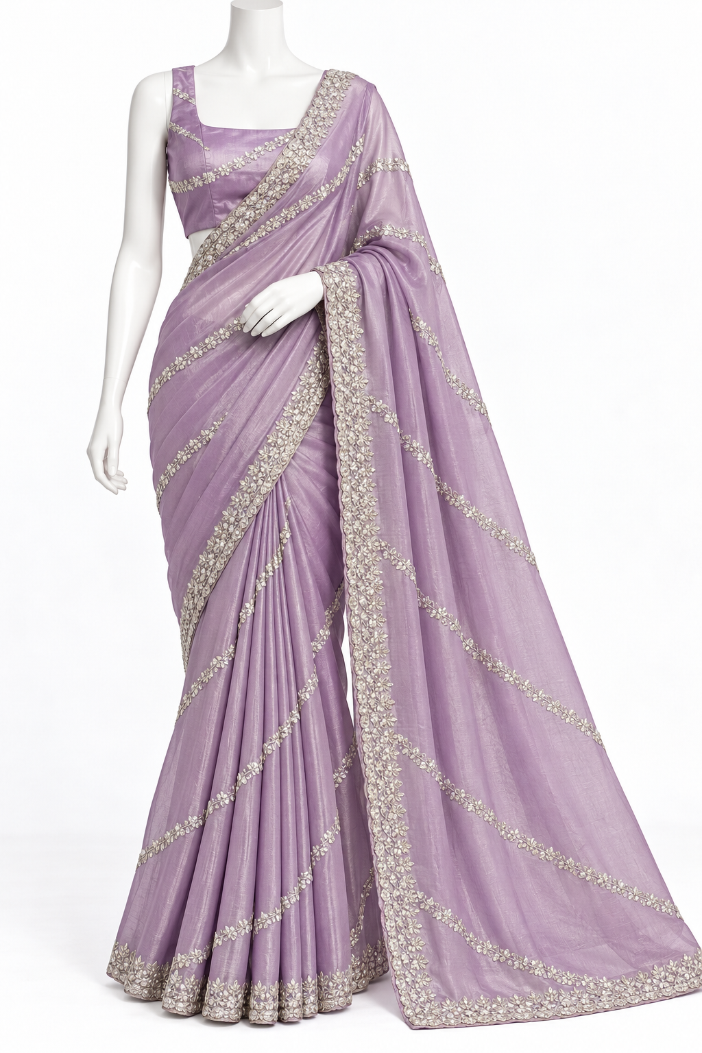 A lavender purple georgette saree with silver floral embroidery, draped on a white mannequin against a plain white background.