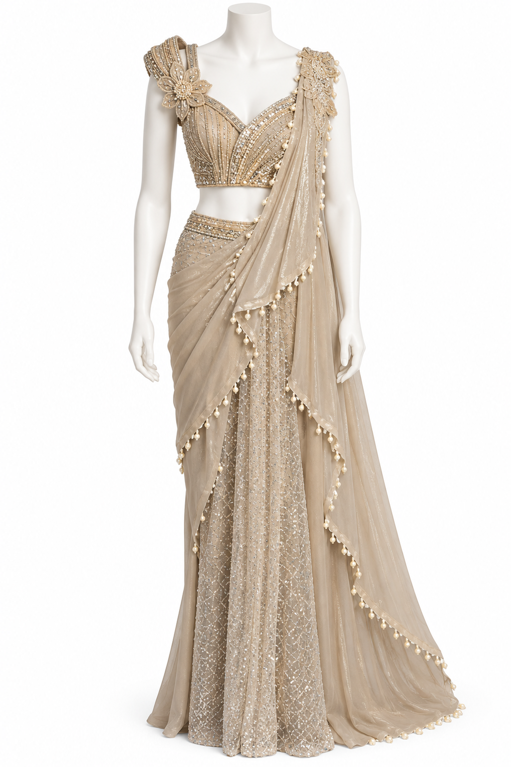A beige and gold embellished traditional Indian gown displayed on a white mannequin against a white background. The dress features a heavily beaded and sequined sweetheart-style bodice with a draped dupatta adorned with gold bead tassels.