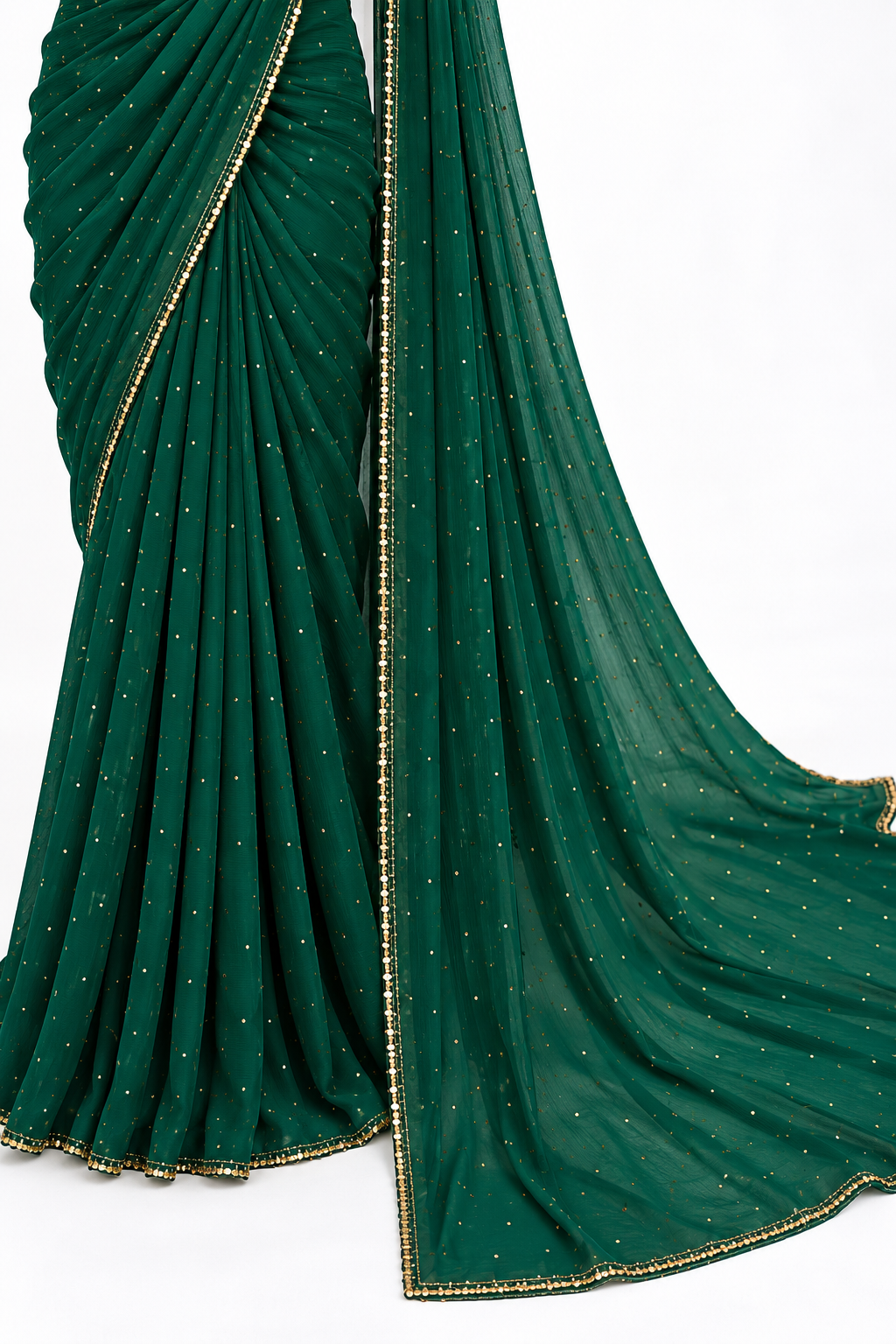 A dark green saree with delicate gold dot patterns and a gold-trimmed border, draped elegantly against a plain white background.