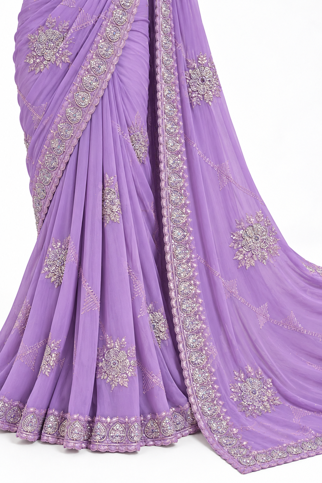 A lavender purple saree with intricate silver and gold floral embroidery and border detailing, draped elegantly against a plain white background.
