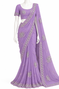 A lavender purple georgette saree with silver floral embroidery, displayed on a white mannequin. The set includes a matching short-sleeve blouse with a scoop neck and a draped saree body with a wide border.