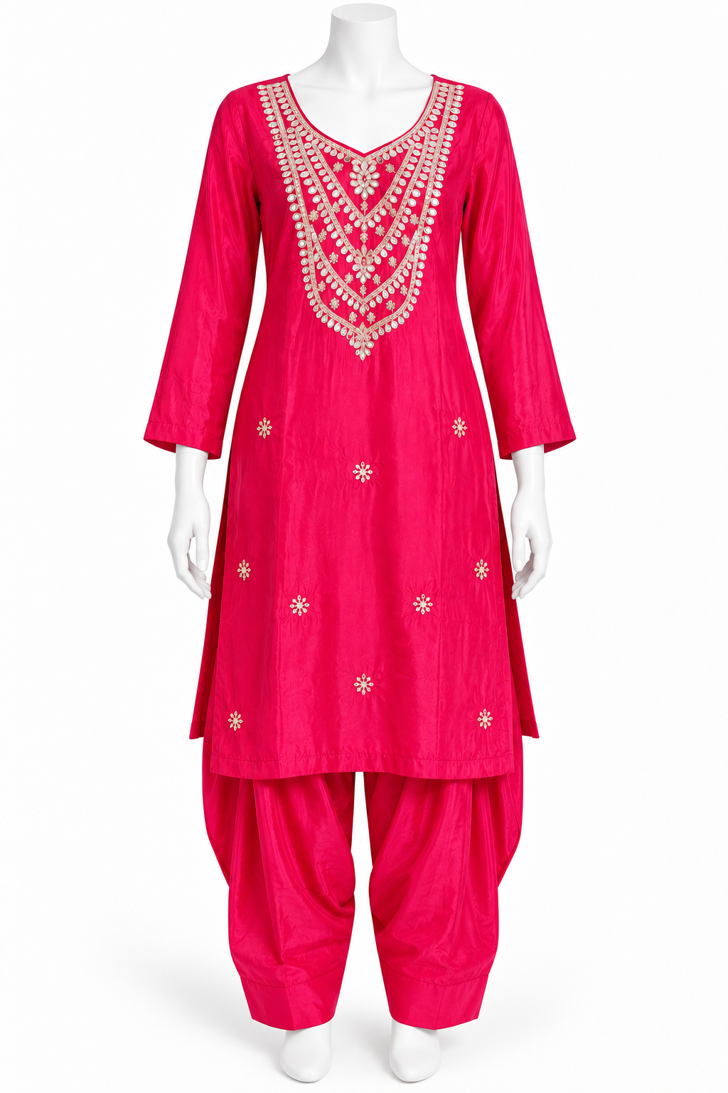 A bright pink Indian ethnic suit set displayed on a white mannequin, featuring a long kurta with intricate silver and gold embroidery around the neckline and scattered motifs on the front, paired with matching flared pants.