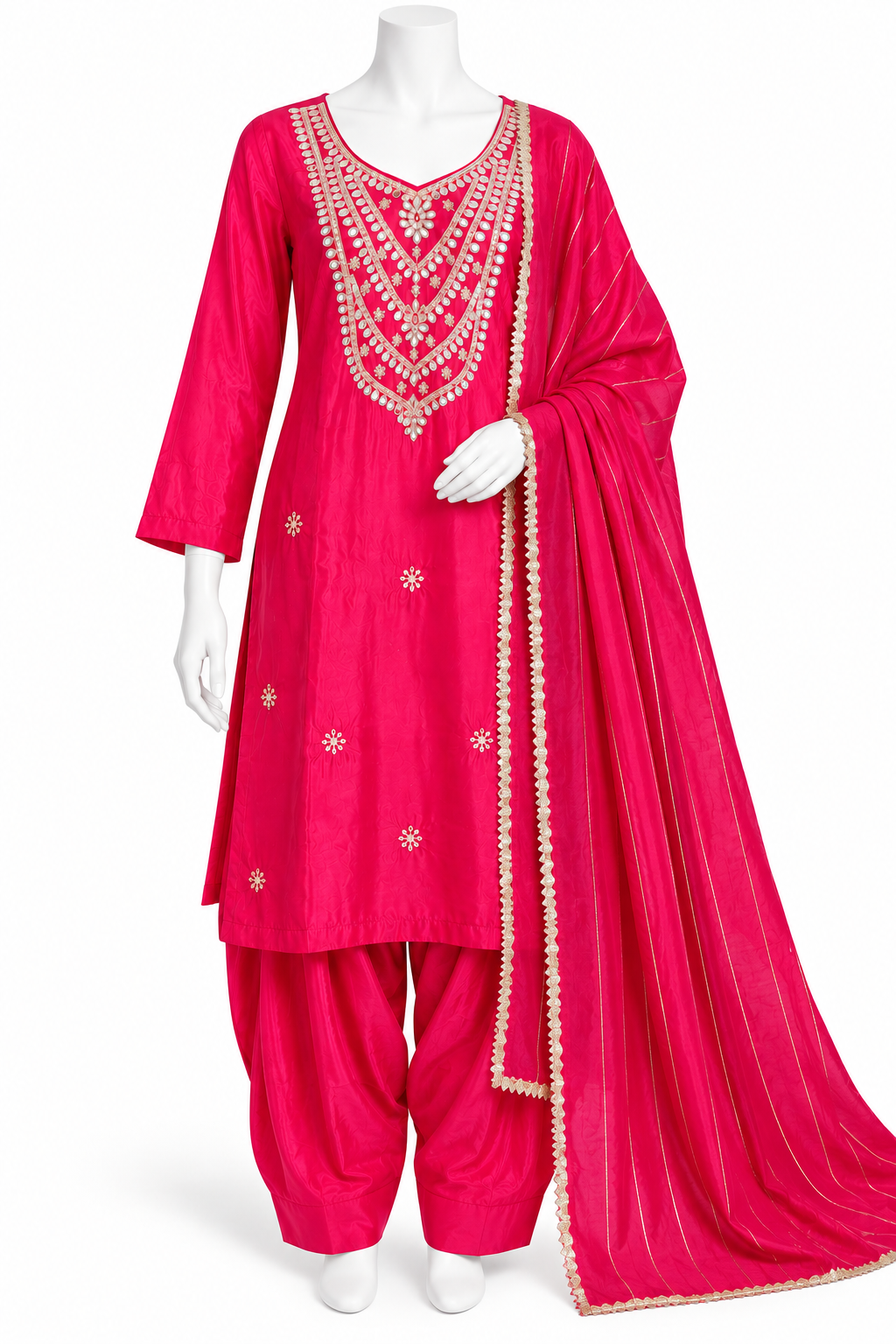 A bright pink traditional Indian salwar kameez suit displayed on a white mannequin. The set includes a pink kurta with intricate gold and silver embroidery around the neckline and scattered motifs on the front, matching pink salwar pants, and a sheer pink dupatta with a gold embroidered border.