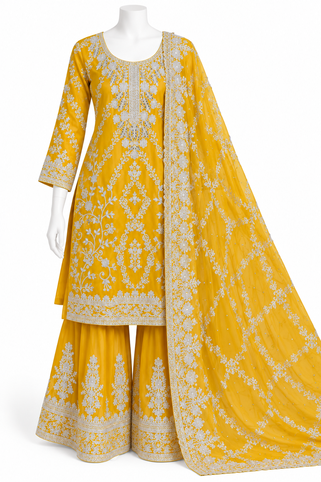 A yellow traditional three-piece outfit displayed on a white mannequin against a white background. The set includes a long-sleeved embroidered kurta, matching wide-leg pants, and a draped dupatta with detailed white embroidery.