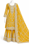 A yellow traditional three-piece outfit displayed on a white mannequin against a white background. The set includes a long-sleeved embroidered kurta, matching wide-leg pants, and a draped dupatta with detailed white embroidery.