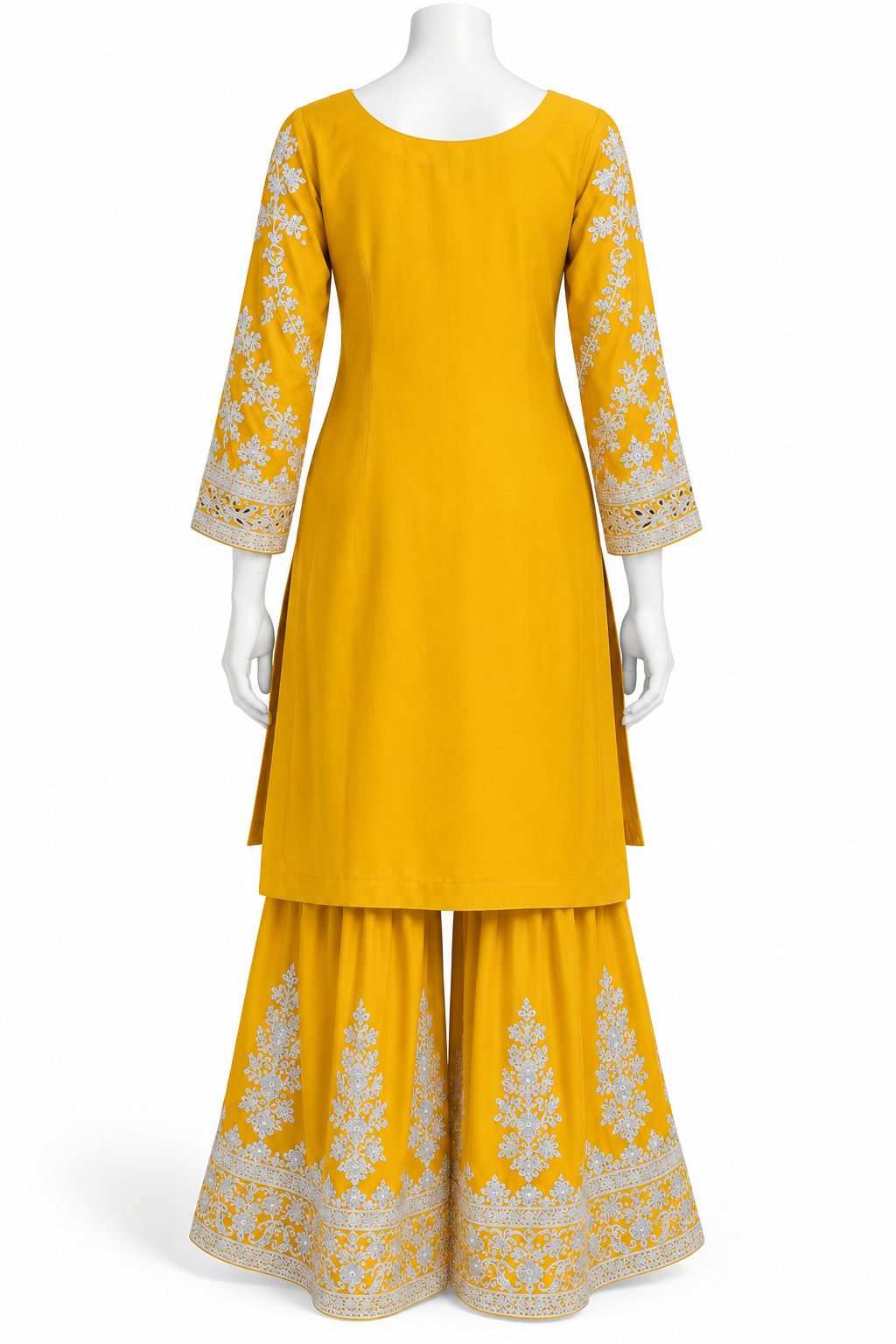 A yellow three-piece traditional outfit displayed on a white mannequin, featuring a straight kurta with white floral embroidery on the sleeves and hem, matching flared sharara pants, and coordinating belt.