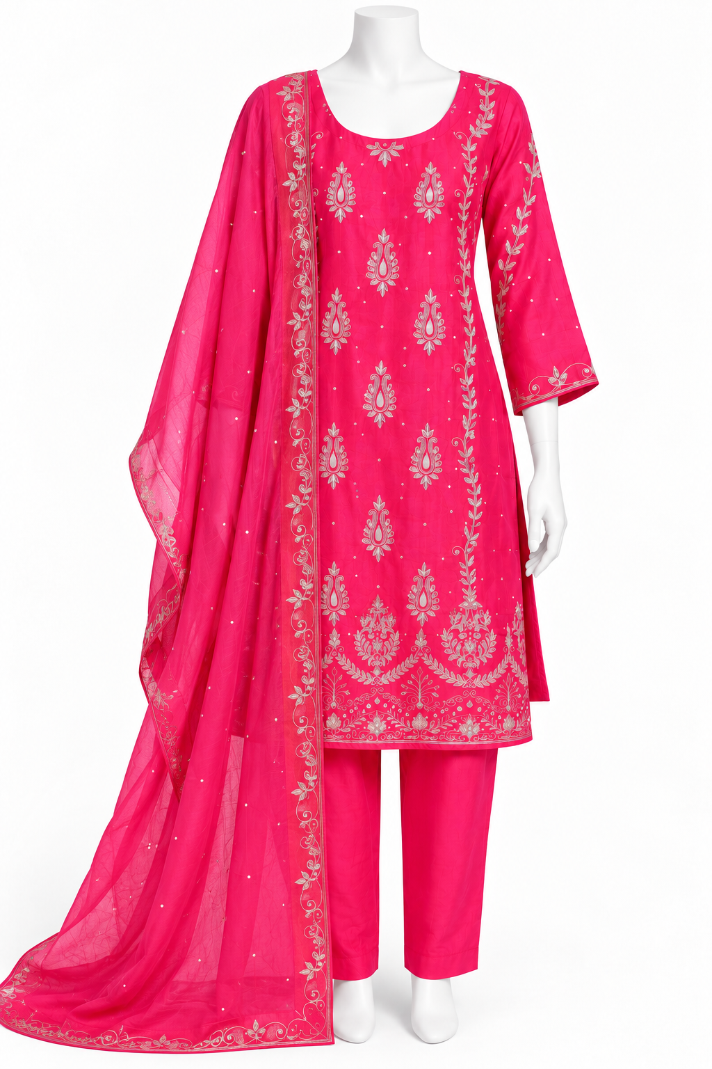 A bright pink three-piece traditional outfit displayed on a white mannequin, featuring a kurta with silver floral embroidery, matching pants, and a sheer dupatta with embroidered borders.
