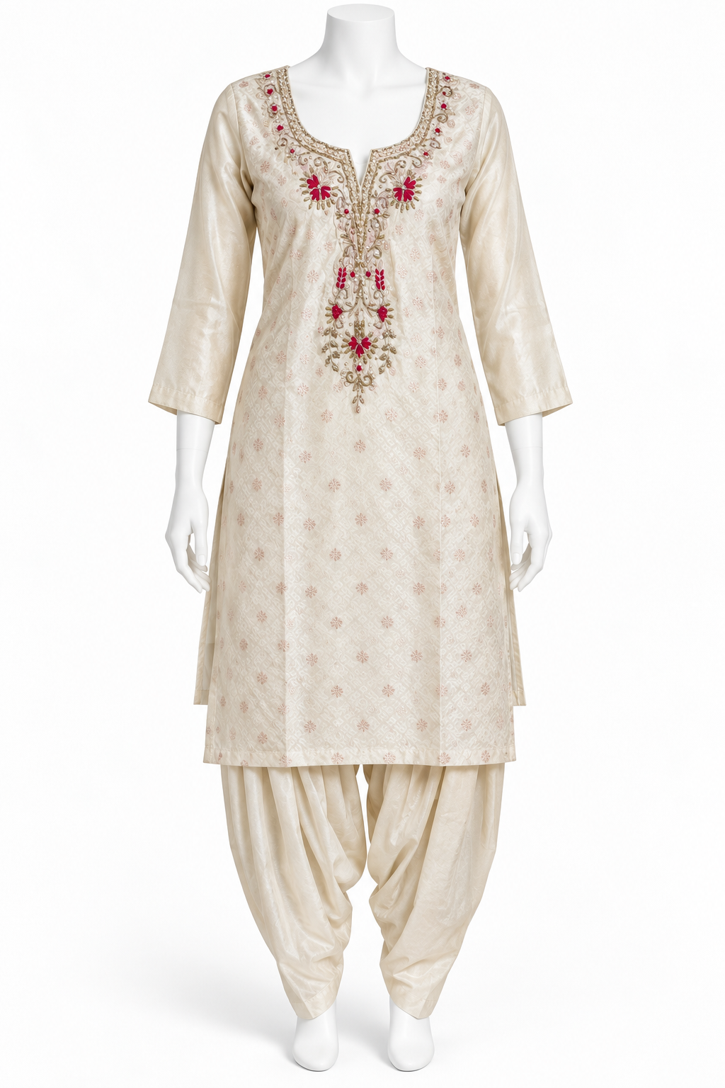 A cream-colored Indian ethnic suit set displayed on a white mannequin, featuring a kurta with red and gold floral embroidery at the neckline and matching beige patola-style pants.